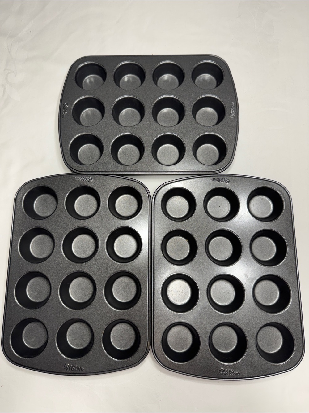 (3) like new Wilton mini muffin/cupcake none-stick baking pans.